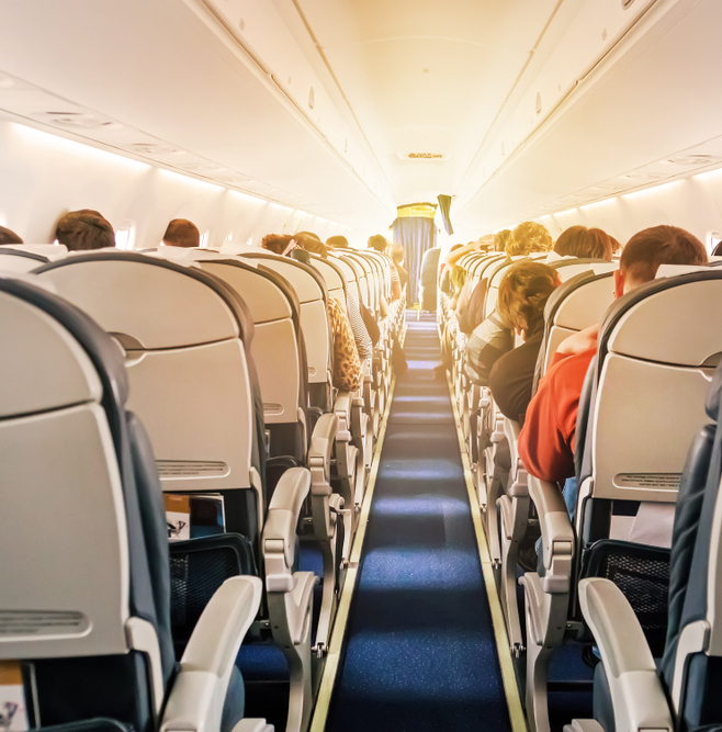 Interior of a commercial airplane full of travelers