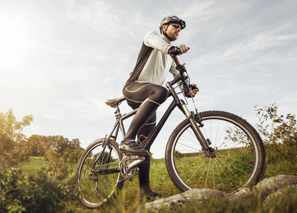 Cyclist on grassy field during mid day