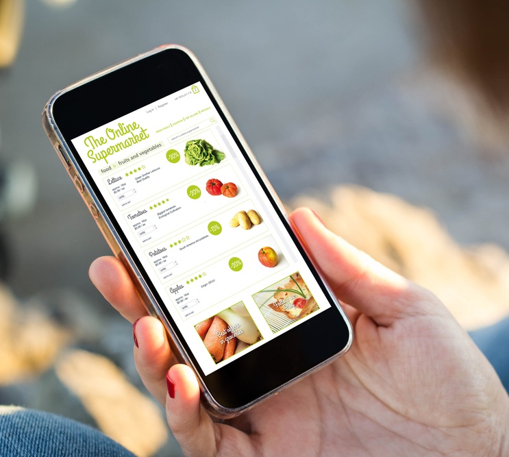 A mobile phone with online supermarket app on screen