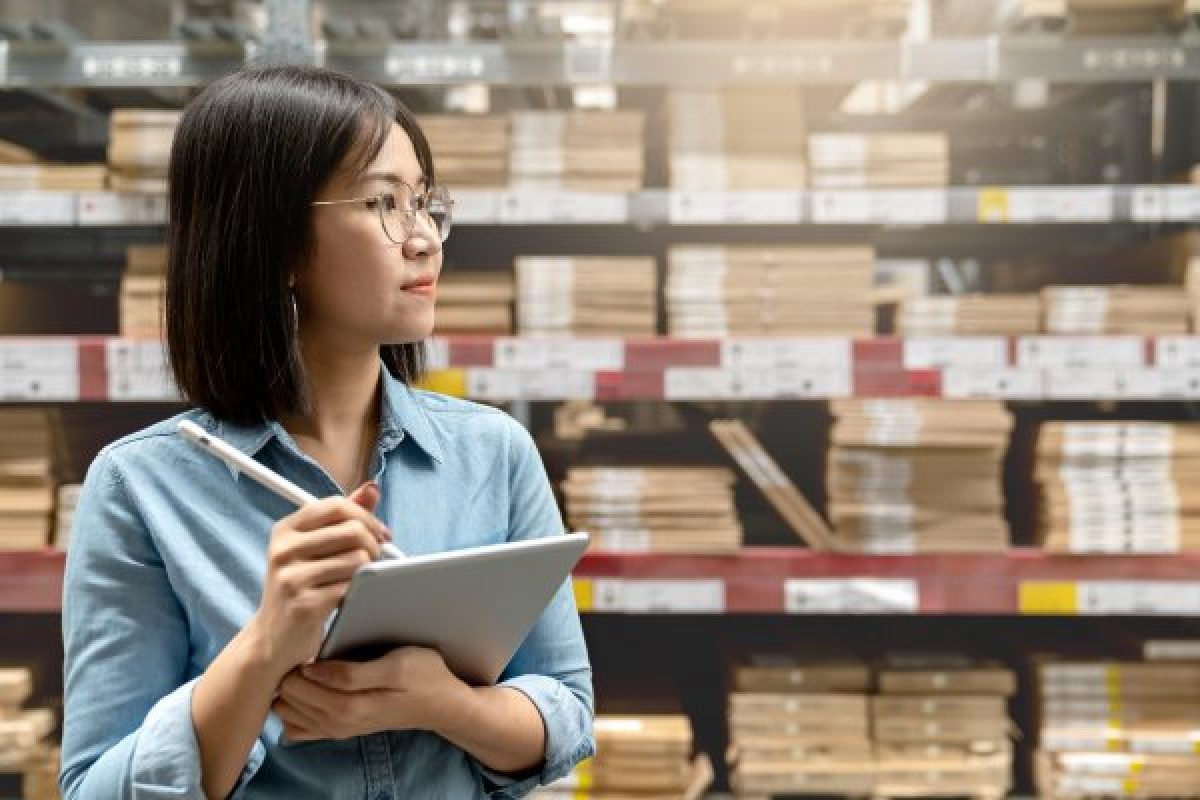 Worker in a warehouse facility full of inventories