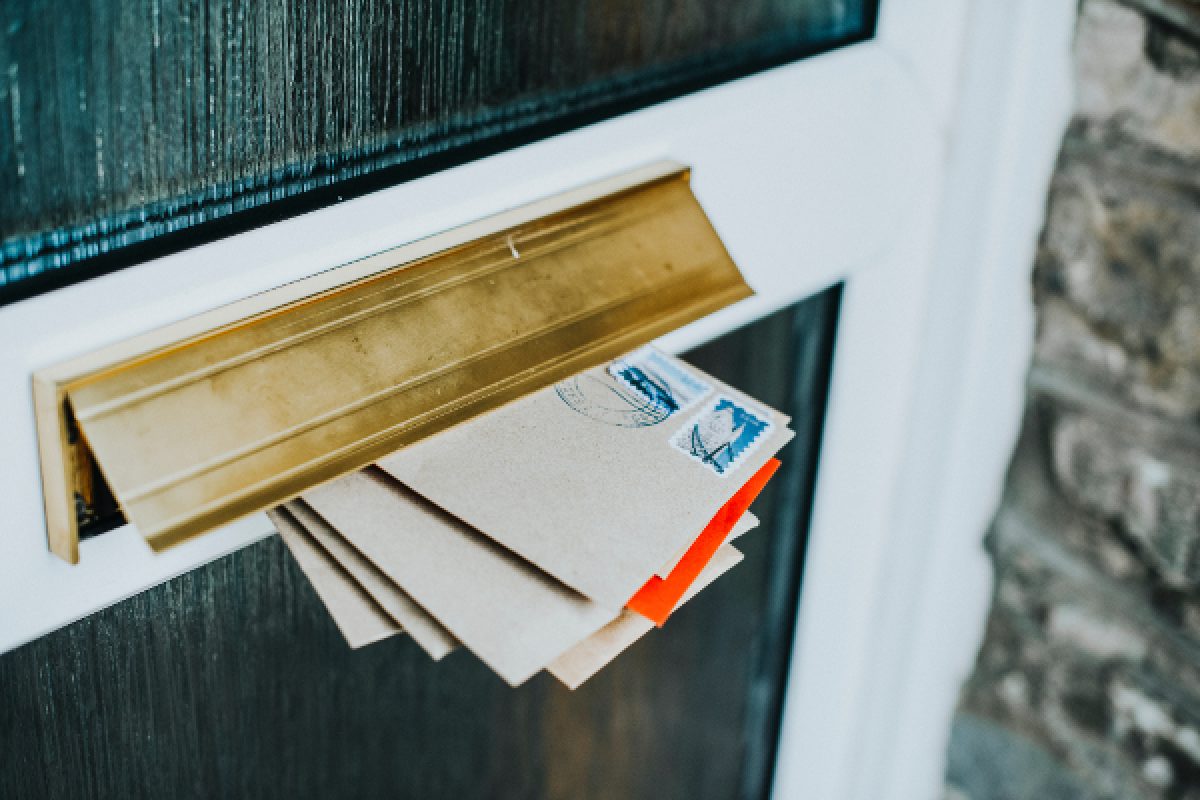 Mail hanging out of a door's post opening